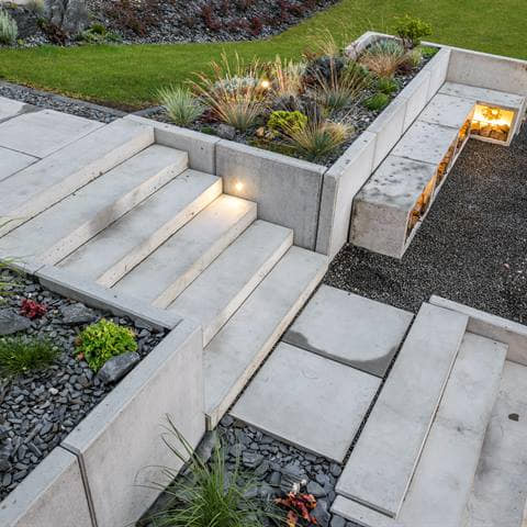Poured concrete steps, slabs and retaining walls with integrated step lighting